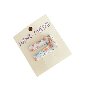 Floral fabric hair clips set with pink and blue flower patterns on a display card