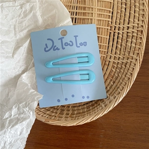 Close-up of light blue enamel BB hair clips on a display card for girls and women