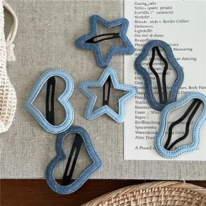 Set of denim blue hair clips in heart, star, and cloud shapes with fabric stitching