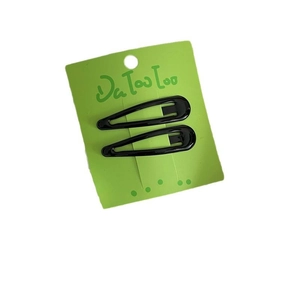Set of two black metal snap hair clips for women displayed on a green paper card