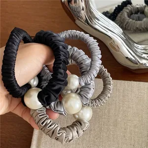 Elegant satin scrunchie set with white faux pearls in black, gray, and champagne colors