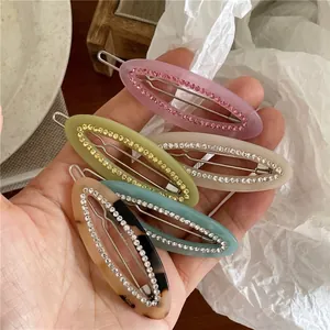 Elegant rhinestone-studded oval hair clips set in pink, green, cream, and blue colors