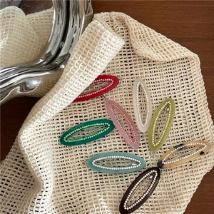 Close-up of 8 colors of acetate oval hair clips with delicate rhinestone edging