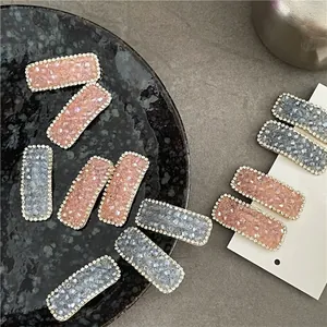 Elegant rectangle hair clips with sparkling pink and blue rhinestones on display