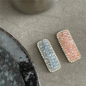 Close-up of luxury rectangular rhinestone hair clip with pink and grey crystals
