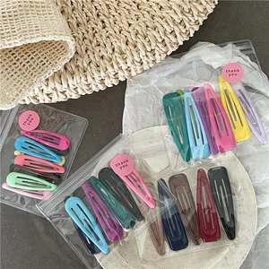 Cute cream-colored teardrop hair clips set in transparent frosted packaging pouches