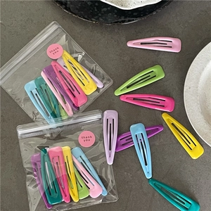 Close-up of colorful macaron BB hair clips in clear packaging with a thank you sticker