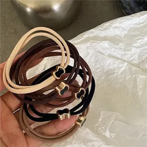 Set di elastici per capelli con ciondoli a quadrifoglio in toni terra, nero e marrone