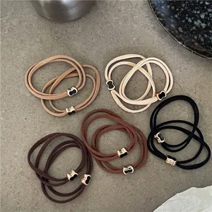 Elastici per capelli a fiocco nero e caffè con eleganti fibbie in metallo dorato