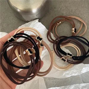 Elastici per capelli a tre fili con ciondoli a cuore dorati in nero, caffè e beige