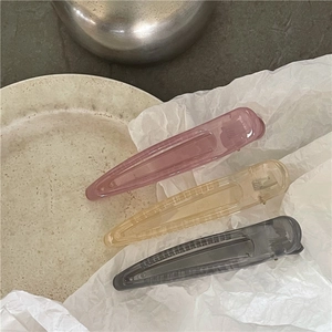 Three long translucent jelly hair clips on white paper showing high-quality acrylic texture