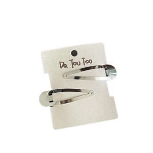 Pair of metallic silver teardrop hair clips with a mirror finish on display card