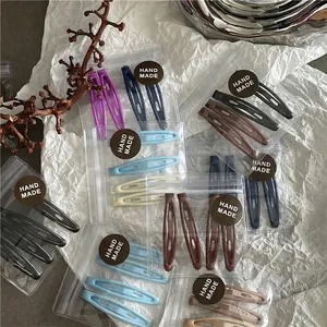 Ensemble de barrettes BB en forme de goutte Morandi dans des sacs transparents sur blanc