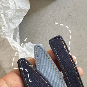 Macro shot of denim fabric hair clips with contrast stitching and metal base details