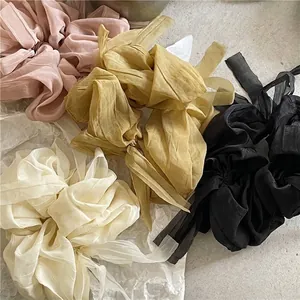 Elegant oversized organza bow scrunchies set with long ribbons in four soft pastel colors
