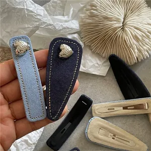Denim fabric hair clips in rectangular and waterdrop shapes with silver heart metal accents