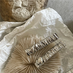 Silver metal rectangular hair clips with hammered texture and 3D heart elements