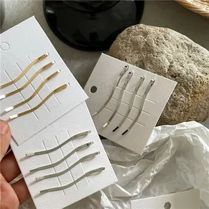 Set di quattro fermagli per capelli a onde in metallo color oro e argento per donna