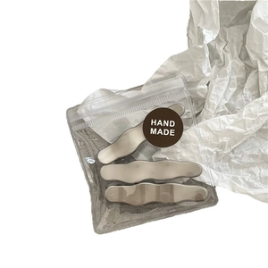 Three-piece set of minimalist wave-shaped beige hair clips in elegant matte metal finish