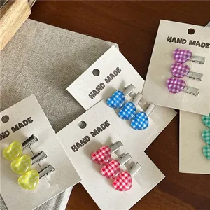 Colorful checkered heart hair clips set in vibrant yellow, red, blue, purple, and green