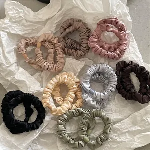Elegant satin scrunchies set in various colors with silky texture and soft folds
