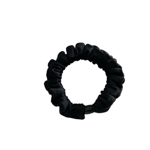 Elegant black satin scrunchie with pleated texture and elastic tie for women's hairstyles