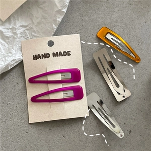 Detailed set of 5 colorful teardrop and rectangular BB hair clips on cardboard display