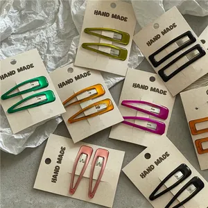 Detailed view of colorful oil-drop BB hair clips in teardrop and rectangular shapes