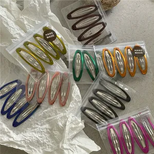 Detailed view of colorful geometric BB clips in transparent gift packaging bags