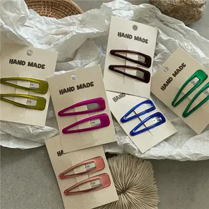 Detailed view of colorful resin snap hair clips in various colors on paper card