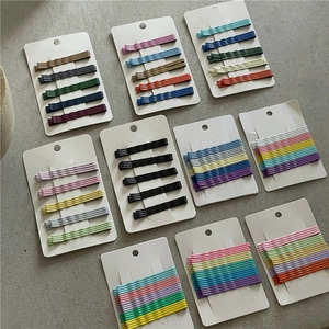 Close-up of pastel rainbow metal bobby pins set in matte finish on display cards