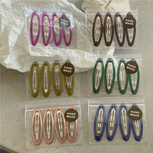 Detailed set of 4 oval geometric drip oil hair clips in six assorted colors with packaging