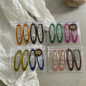 Set of colorful resin oval BB hair clips in diverse translucent finishes and packaging