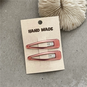 Macro shot of colorful drip oil teardrop snap clips on a Hand Made display card