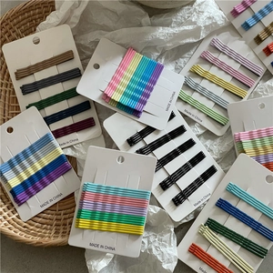 Close-up of colorful wave hair clips set on paper cards in a woven basket display