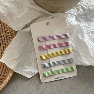 Detail view of 20 pieces colorful pastel wavy bobby pins set on a white display card