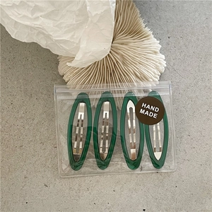 Set of four dark green oval resin BB hair clips in delicate handmade packaging