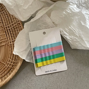 Detailed macro view of 10-piece matte macaron wave hair pins on white display card