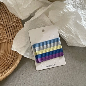 Set of 10 colorful wavy bobby pins in cream pastel tones displayed on a white card