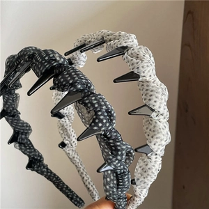 Detailed view of breathable polka dot fabric headbands with non-slip inner teeth grip