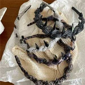 Detail of leopard and polka dot mesh headbands with non-slip teeth for secure styling