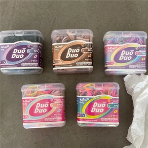Detail view of five boxes of high elasticity colorful TPU hair bands for kids and girls