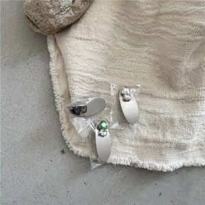 Detail of silver alloy hair clips with heart and emerald-cut faux gemstones