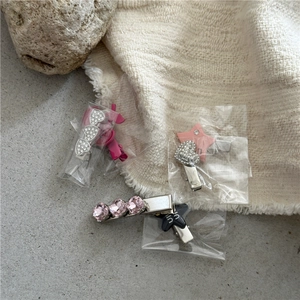Close-up of sweet Korean style hair clips with heart rhinestones and pink stars