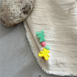 Detailed macro view of creative green and yellow resin hair clips with ribbed texture