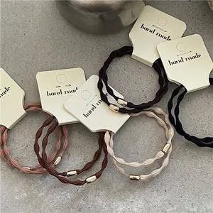 Minimalist elastic hair ties set with golden beads in black and brown earth tones