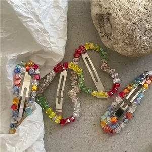 Luxurious four-piece colorful crystal beaded heart hair clips on aesthetic stone background