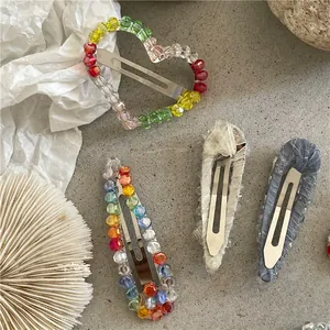Detailed macro view of heart and teardrop hair clips with crystal beads and lace fabric