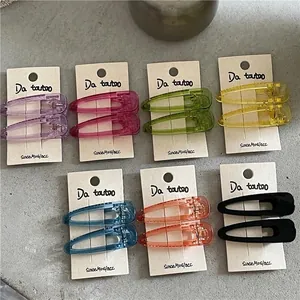Set of colorful translucent drop-shaped hair clips in seven bright acrylic shades