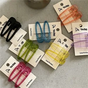 Detail of multi-colored translucent drop hair clips in seven colors on card boards